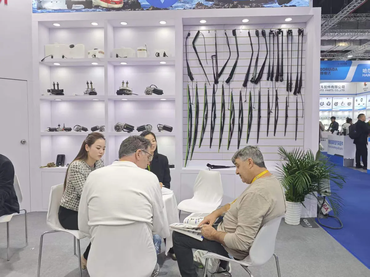 Buyers reviewing the LEILI wiper catalog at Booth 4.1C100, Automechanika Shanghai 2025