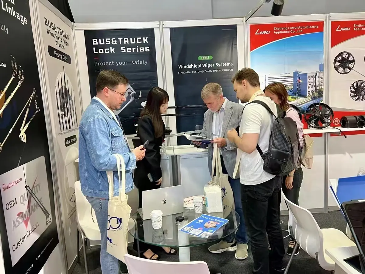 Buyers reviewing the LEILI wiper system catalog at Booth 3-F44, Busworld Türkiye 2024