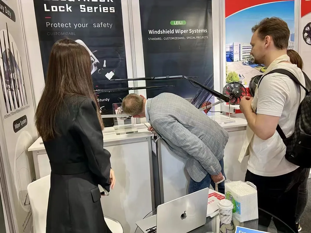Visitor examining heavy-duty wiper arms and blades at the LEILI booth, Busworld Türkiye 2024